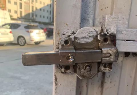 Cerrojo de seguridad de sobreponer instalado en una puerta metálica